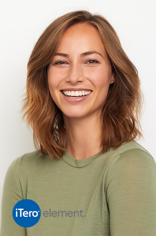 A woman is smiling on a studio background
